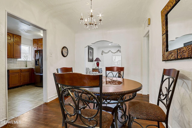 816 Ellis St, El Paso, TX 79903 - dining space featuring wood-type flooring, a chandelier, and baseboards
