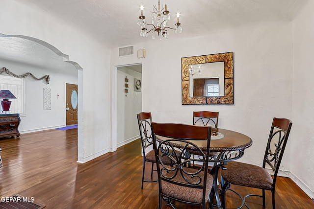 816 Ellis St, El Paso, TX 79903 - dining area with arched walkways, wood finished floors, baseboards, and a chandelier