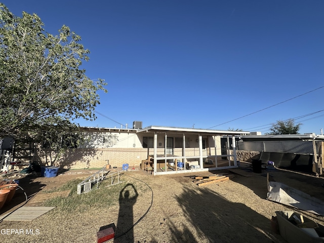 10477 Mackinaw St, El Paso, TX 79924 - back of property featuring a sunroom and brick siding