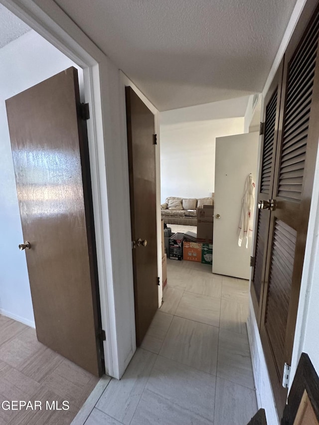 10477 Mackinaw St, El Paso, TX 79924 - hall featuring a textured ceiling