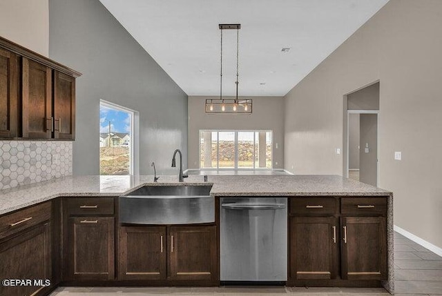 3928 Aspiration, El Paso, TX 79934 - kitchen with stainless steel dishwasher, a sink, healthy amount of natural light, light stone counters, and lofted ceiling