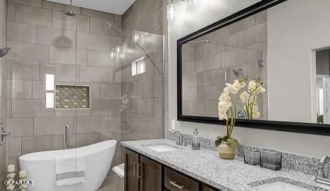 3928 Aspiration, El Paso, TX 79934 - full bathroom with double vanity, a shower stall, and a soaking tub