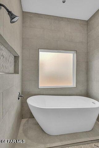 3928 Aspiration, El Paso, TX 79934 - bathroom featuring a soaking tub, tile patterned floors, and tile walls