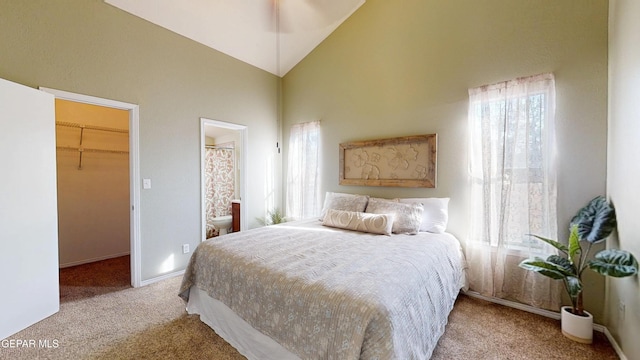 684 Abington Dr, El Paso, TX 79912 - bedroom featuring light colored carpet, multiple windows, a spacious closet, and high vaulted ceiling