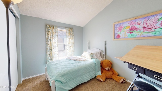 684 Abington Dr, El Paso, TX 79912 - bedroom with carpet flooring, vaulted ceiling, a textured ceiling, and baseboards