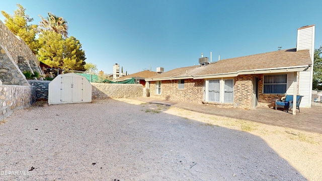 684 Abington Dr, El Paso, TX 79912 - rear view of property with a fenced backyard, brick siding, a chimney, and a patio area