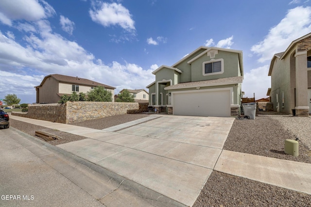 7044 Eagle Nest Ct, El Paso, TX 79934 - view of front facade with driveway, a garage, stone siding, and stucco siding