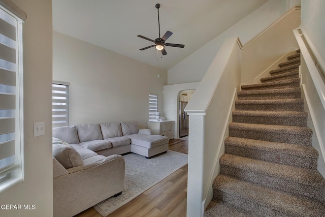 7044 Eagle Nest Ct, El Paso, TX 79934 - living area featuring wood finished floors, a ceiling fan, stairs, and high vaulted ceiling