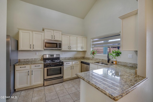 7044 Eagle Nest Ct, El Paso, TX 79934 - kitchen featuring stainless steel appliances, high vaulted ceiling, a peninsula, a sink, and light tile patterned floors