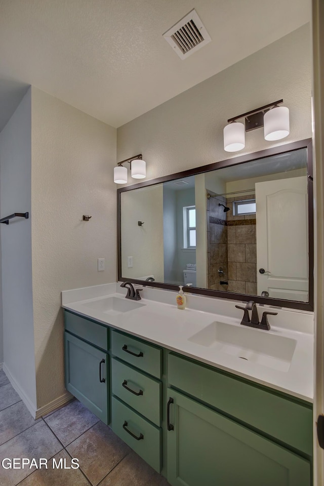 7044 Eagle Nest Ct, El Paso, TX 79934 - full bath with double vanity, a shower, tile patterned floors, and baseboards