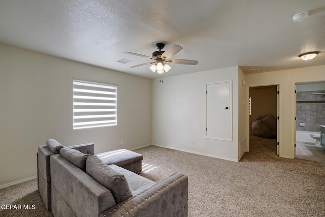 7044 Eagle Nest Ct, El Paso, TX 79934 - living area with carpet floors, a ceiling fan, baseboards, and a textured ceiling
