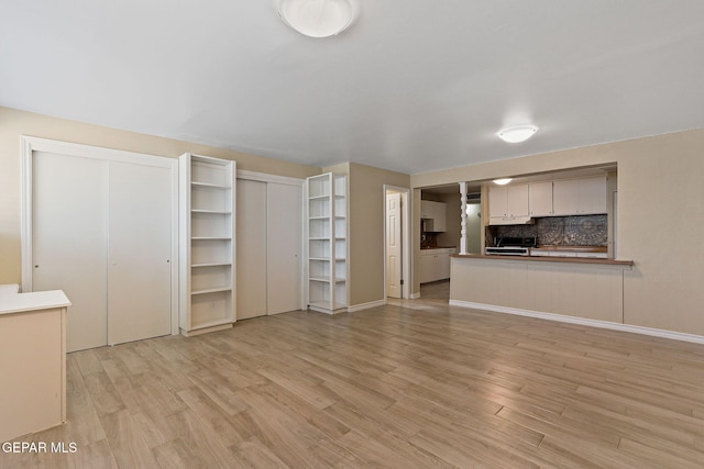 310 Kelvin Ave, El Paso, TX 79915 - unfurnished living room with light wood-style flooring and baseboards