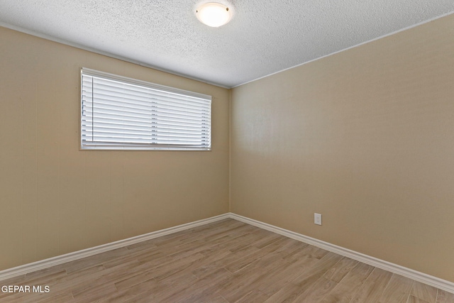 310 Kelvin Ave, El Paso, TX 79915 - spare room with light wood-style flooring, a textured ceiling, and baseboards