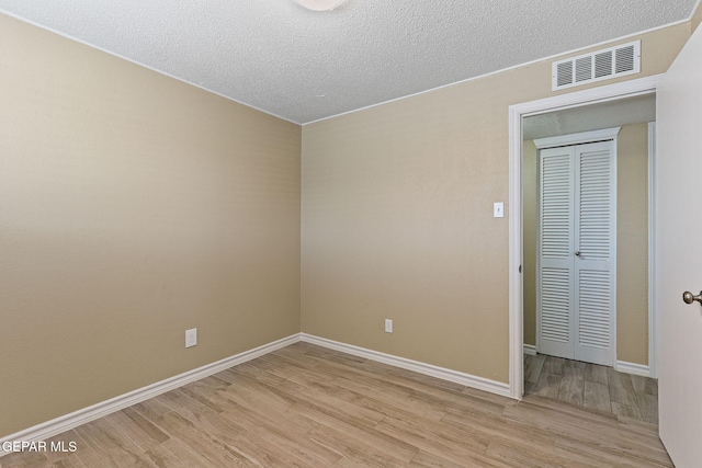 310 Kelvin Ave, El Paso, TX 79915 - empty room with light wood-style flooring, baseboards, and a textured ceiling