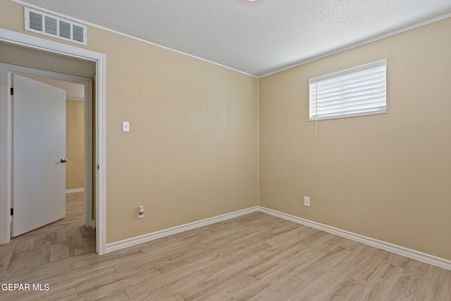 310 Kelvin Ave, El Paso, TX 79915 - unfurnished room featuring light wood-type flooring, a textured ceiling, baseboards, and crown molding