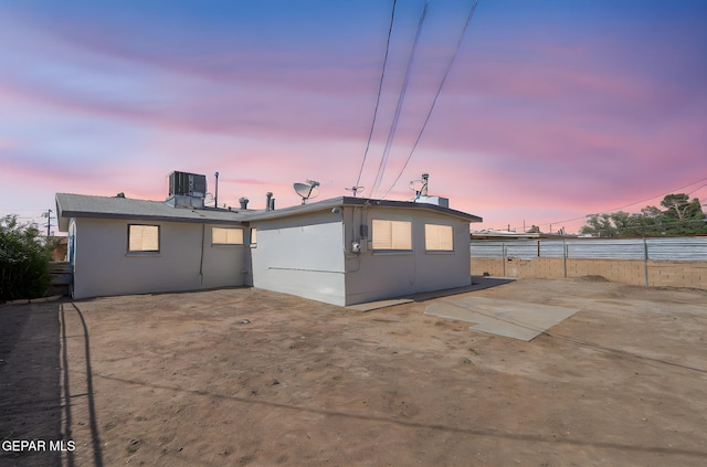 310 Kelvin Ave, El Paso, TX 79915 - back of house at dusk with a patio area, central AC unit, and stucco siding