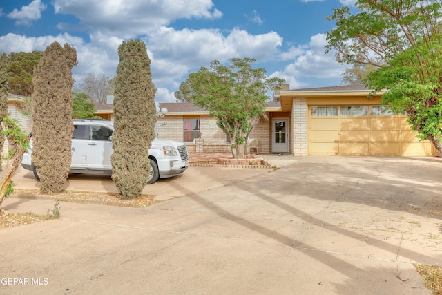 11625 Soberana Ln Unit A & B, El Paso, TX 79936 - view of front facade featuring brick siding, driveway, and an attached garage