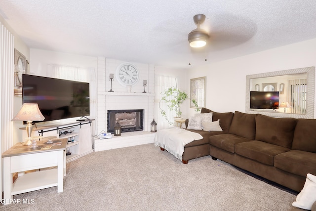 11625 Soberana Ln Unit A & B, El Paso, TX 79936 - living room with carpet flooring, ceiling fan, a brick fireplace, plenty of natural light, and a textured ceiling