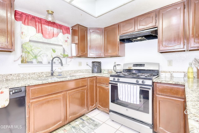 11625 Soberana Ln Unit A & B, El Paso, TX 79936 - kitchen with stainless steel gas range oven, dishwashing machine, under cabinet range hood, a sink, and light tile patterned flooring