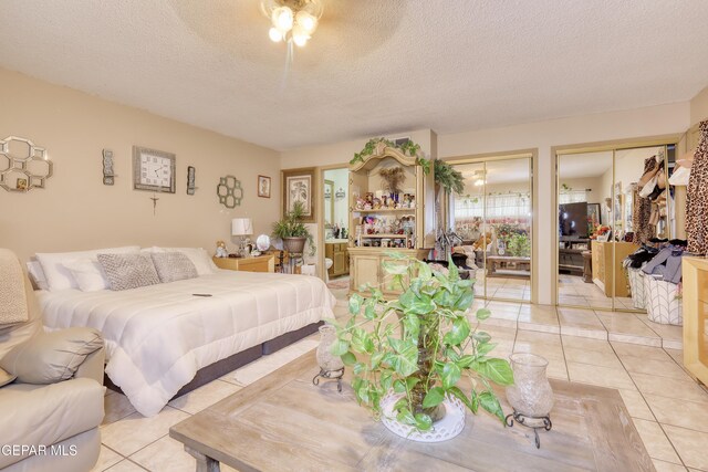 11625 Soberana Ln Unit A & B, El Paso, TX 79936 - bedroom with light tile patterned floors, multiple closets, a textured ceiling, and ceiling fan