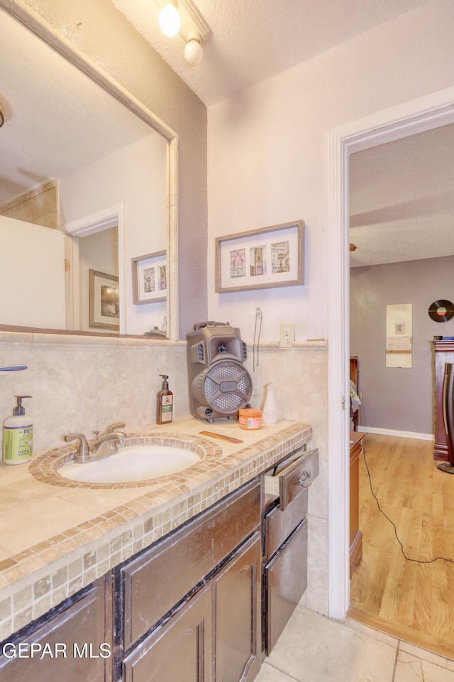 11625 Soberana Ln Unit A & B, El Paso, TX 79936 - bathroom featuring vanity, backsplash, a textured ceiling, and tile patterned flooring