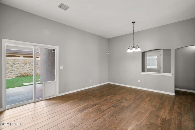 13519 Hazlewood St, El Paso, TX 79928 - unfurnished room featuring wood finished floors, a chandelier, and baseboards