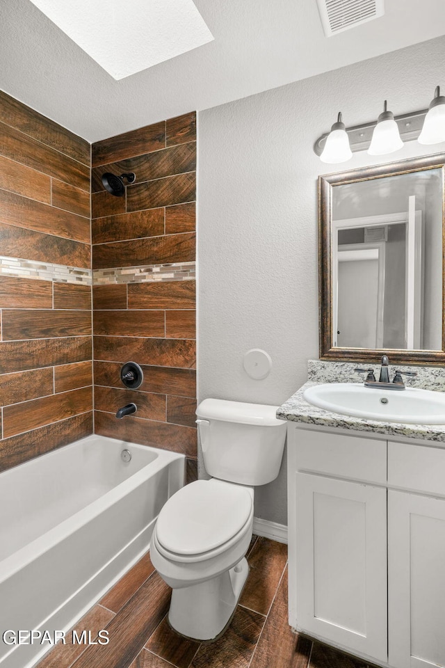 13519 Hazlewood St, El Paso, TX 79928 - full bathroom with toilet, vanity, shower / bathtub combination, a skylight, and baseboards