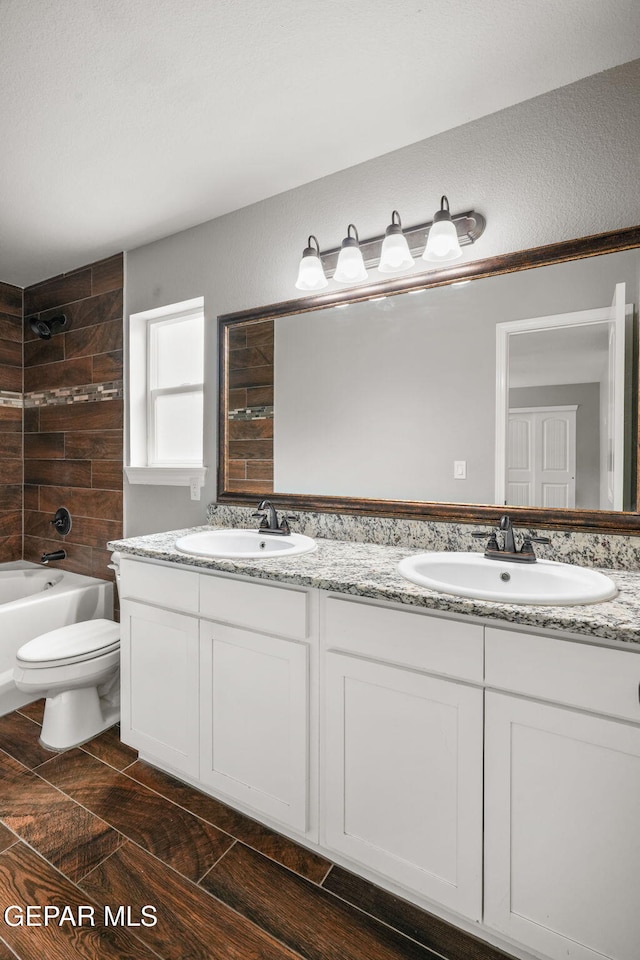 13519 Hazlewood St, El Paso, TX 79928 - bathroom featuring double vanity, toilet, bathing tub / shower combination, and tile patterned flooring