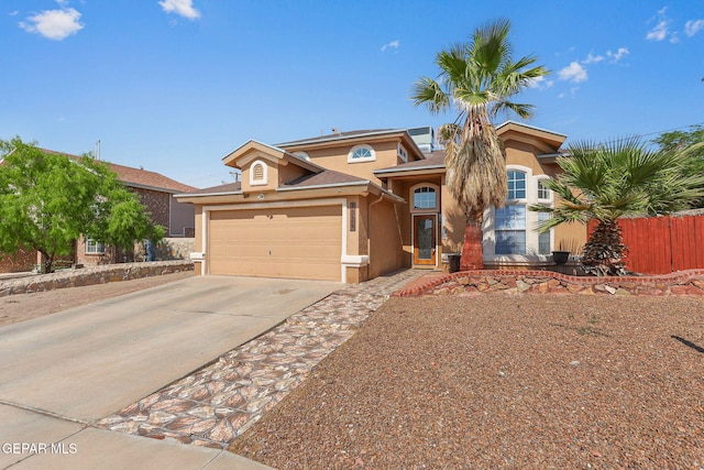1328 Morgan Marie St, El Paso, TX 79936 - view of front facade with stucco siding, concrete driveway, and a garage