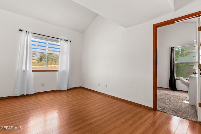 1328 Morgan Marie St, El Paso, TX 79936 - spare room featuring light wood-style floors, vaulted ceiling, and baseboards