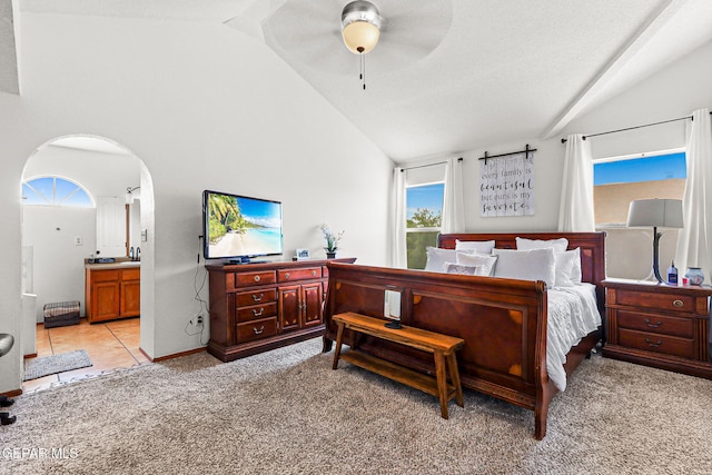 1328 Morgan Marie St, El Paso, TX 79936 - bedroom featuring light colored carpet, arched walkways, connected bathroom, high vaulted ceiling, and ceiling fan