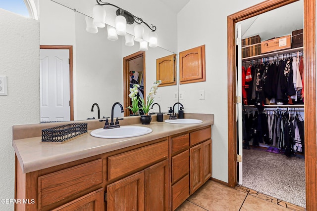 1328 Morgan Marie St, El Paso, TX 79936 - bathroom with double vanity, tile patterned flooring, and a spacious closet