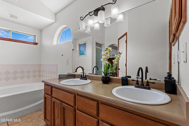 1328 Morgan Marie St, El Paso, TX 79936 - full bathroom featuring double vanity, a garden tub, and tile patterned flooring