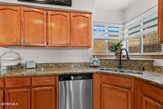 1328 Morgan Marie St, El Paso, TX 79936 - kitchen featuring dishwasher, a sink, dark stone counters, and brown cabinetry