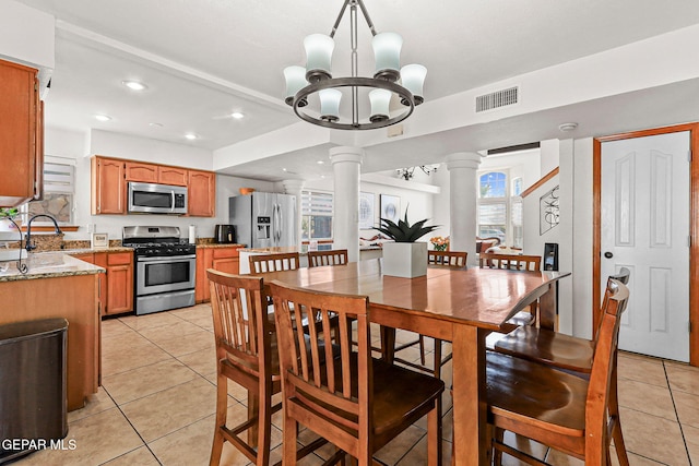1328 Morgan Marie St, El Paso, TX 79936 - dining area with decorative columns, light tile patterned floors, recessed lighting, and a chandelier