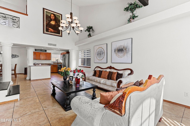 1328 Morgan Marie St, El Paso, TX 79936 - living area with a chandelier, a towering ceiling, baseboards, light tile patterned floors, and ornate columns