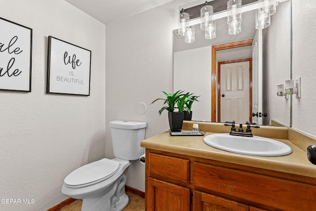1328 Morgan Marie St, El Paso, TX 79936 - half bath featuring toilet, vanity, baseboards, and a textured wall