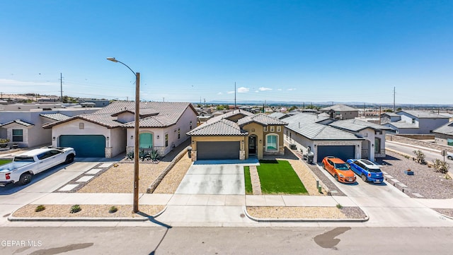 12826 Osmotherly Ave, El Paso, TX 79928 - mediterranean / spanish-style house with a garage, stucco siding, a residential view, and driveway