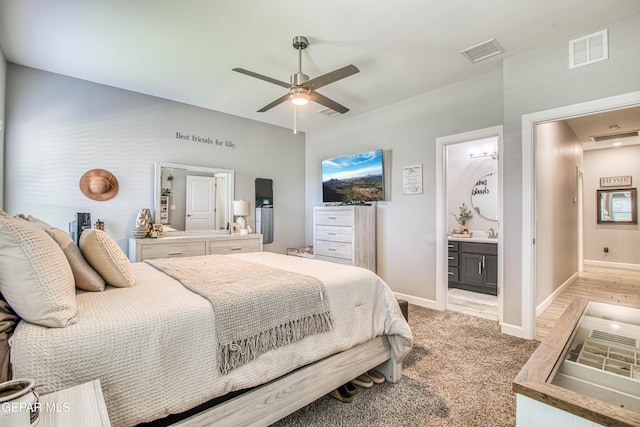 12826 Osmotherly Ave, El Paso, TX 79928 - bedroom with baseboards, light colored carpet, a ceiling fan, and ensuite bathroom