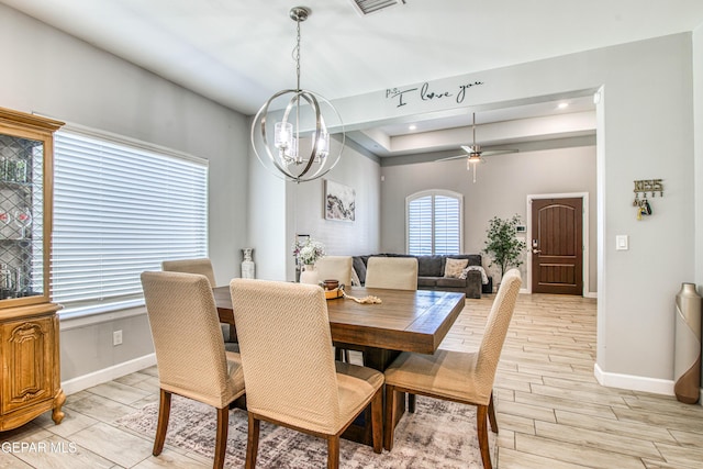 12826 Osmotherly Ave, El Paso, TX 79928 - dining room featuring baseboards, wood tiled floors, a tray ceiling, and a ceiling fan