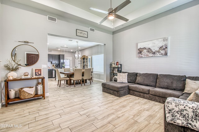 12826 Osmotherly Ave, El Paso, TX 79928 - living area with a high ceiling, ceiling fan, light wood-style floors, and baseboards