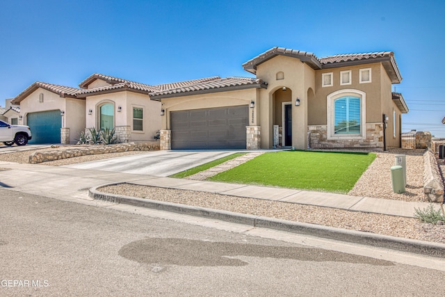 12826 Osmotherly Ave, El Paso, TX 79928 - mediterranean / spanish-style home featuring stone siding, an attached garage, stucco siding, concrete driveway, and a tile roof