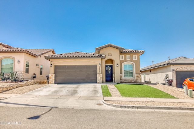 12826 Osmotherly Ave, El Paso, TX 79928 - mediterranean / spanish-style house with stone siding, stucco siding, a garage, and concrete driveway