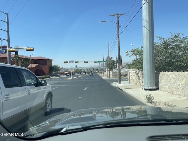 5608 Paraguay Ct, El Paso, TX 79903 - view of asphalt road featuring traffic lights, street lighting, and sidewalks