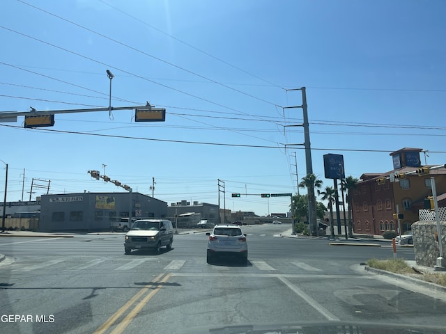 5608 Paraguay Ct, El Paso, TX 79903 - view of asphalt road with traffic lights, curbs, sidewalks, and street lighting