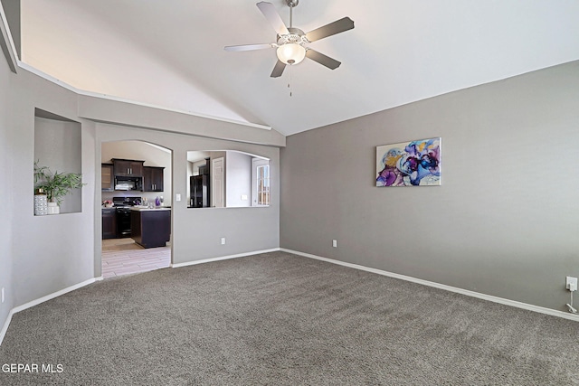 401 Gran Villa Pl, Socorro, TX 79927 - spare room with light carpet, a ceiling fan, lofted ceiling, arched walkways, and baseboards