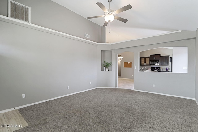 401 Gran Villa Pl, Socorro, TX 79927 - unfurnished room featuring a ceiling fan, arched walkways, light colored carpet, baseboards, and high vaulted ceiling