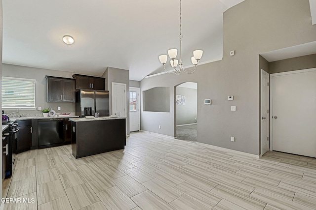 401 Gran Villa Pl, Socorro, TX 79927 - kitchen with stainless steel refrigerator with ice dispenser, black dishwasher, arched walkways, light countertops, and a center island