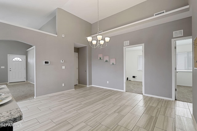 401 Gran Villa Pl, Socorro, TX 79927 - unfurnished room with high vaulted ceiling, arched walkways, a chandelier, baseboards, and wood tiled floors