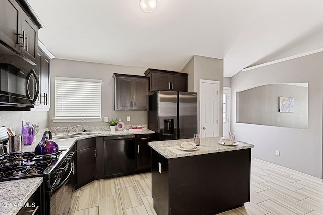 401 Gran Villa Pl, Socorro, TX 79927 - kitchen with black appliances, a sink, a kitchen island, dark brown cabinetry, and vaulted ceiling
